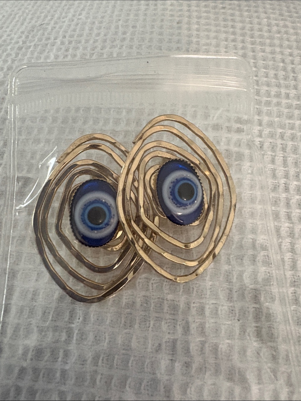 Gold Spiral Eye Drop Earrings with Blue Glass Center